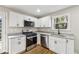 Well-equipped kitchen featuring stainless steel appliances, granite countertops and shaker cabinets at 2740 Dale Creek Nw Dr, Atlanta, GA 30318