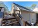 Back deck with stairs leading down, overlooking the yard at 8245 Mill Run Trl, Whitesburg, GA 30185