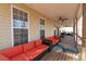 Spacious covered deck featuring outdoor seating, ceiling fans, and woodland view at 8245 Mill Run Trl, Whitesburg, GA 30185