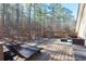 Inviting wooden deck featuring outdoor furniture and scenic views of the surrounding woods at 8245 Mill Run Trl, Whitesburg, GA 30185