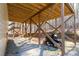 Underneath the deck shows sturdy support structure and yard equipment at 8245 Mill Run Trl, Whitesburg, GA 30185