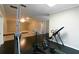 Exercise room with workout machines and a view into the spacious finished basement at 8245 Mill Run Trl, Whitesburg, GA 30185