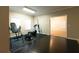 Home gym boasts wood flooring and natural light with an open doorway to living room at 8245 Mill Run Trl, Whitesburg, GA 30185