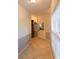 Hallway with tiled flooring, white door, and window with blinds at 8245 Mill Run Trl, Whitesburg, GA 30185