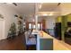 View of the open kitchen with bar seating and easy access to the adjacent living area at 8245 Mill Run Trl, Whitesburg, GA 30185