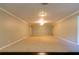 Spacious and bright living room with neutral carpeting and recessed lighting at 8245 Mill Run Trl, Whitesburg, GA 30185