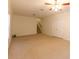 Spacious carpeted living room features a ceiling fan and staircase to the left at 8245 Mill Run Trl, Whitesburg, GA 30185