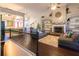 Open-concept living room with a fireplace and built-in shelving, seamlessly connecting to the kitchen at 8245 Mill Run Trl, Whitesburg, GA 30185