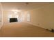 Expansive living area with plush carpeting, bright windows, and ceiling fan at 8245 Mill Run Trl, Whitesburg, GA 30185