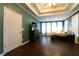 Large bedroom with tray ceilings, and ample natural light from multiple windows with window treatments at 8245 Mill Run Trl, Whitesburg, GA 30185