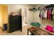 A well-lit walk-in closet with shelving and a view into the bathroom at 8245 Mill Run Trl, Whitesburg, GA 30185