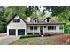 Charming two-story home features a covered porch, two-car garage, and landscaped front yard at 225 Powder Creek Dr, Dallas, GA 30157