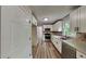 Modern kitchen with stainless steel appliances, white cabinets, and stone backsplash at 225 Powder Creek Dr, Dallas, GA 30157