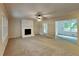 Bright living room with a painted brick fireplace and large window overlooking the backyard at 225 Powder Creek Dr, Dallas, GA 30157