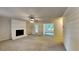 Bright living room with a painted brick fireplace and a view into the sunroom at 225 Powder Creek Dr, Dallas, GA 30157