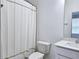 Clean bathroom showcasing a white vanity, toilet, and a shower with a neutral-colored curtain at 3255 Bartee Walk, Suwanee, GA 30024