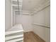 Walk-in closet with built-in shelving and hardwood floors at 4558 Devonshire Rd, Atlanta, GA 30338