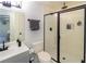 Bathroom with glass door shower, gray vanity, black fixtures, and tile floors at 709 Berkeley Woods Dr # 709, Duluth, GA 30096