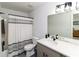 Modern bathroom featuring a white vanity, updated fixtures, and a shower with tile surround at 709 Berkeley Woods Dr # 709, Duluth, GA 30096