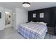 Bedroom with wood floors and a view to the bathroom, black headboard, and ceiling fan at 709 Berkeley Woods Dr # 709, Duluth, GA 30096
