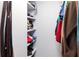 Walk-in closet with organized shelving and hanging clothes at 709 Berkeley Woods Dr # 709, Duluth, GA 30096