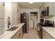Modern kitchen with stainless steel appliances, gray cabinetry, and granite countertops at 709 Berkeley Woods Dr # 709, Duluth, GA 30096