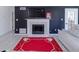 Cozy living room showcasing a modern fireplace, a large TV, and gray wood-look floors at 709 Berkeley Woods Dr # 709, Duluth, GA 30096