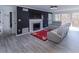 Living room with natural light, black accent wall with fireplace, and comfortable seating at 709 Berkeley Woods Dr # 709, Duluth, GA 30096