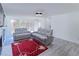 Spacious living room with large windows, gray couches, and stylish lighting at 709 Berkeley Woods Dr # 709, Duluth, GA 30096
