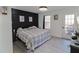 Spacious main bedroom with hardwood floors, a dark accent wall, and natural light at 709 Berkeley Woods Dr # 709, Duluth, GA 30096