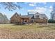 A stone house with a beautiful backyard and pergola on a sunny day at 212 Lakeview Dr, Newborn, GA 30056