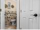 Bathroom featuring neutral tile, toilet, and wall decor at 212 Lakeview Dr, Newborn, GA 30056