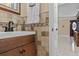 Bathroom featuring modern sink and faucet, neutral tile, and vanity with wood cabinets at 212 Lakeview Dr, Newborn, GA 30056