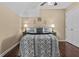 Bedroom with wood floors, ceiling fan, lamps, and a stylish bedspread at 212 Lakeview Dr, Newborn, GA 30056