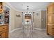 Bright breakfast nook boasts a charming chandelier and a large window with a view of the outdoors at 212 Lakeview Dr, Newborn, GA 30056