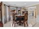 Cozy dining area with a round wooden table, upholstered chairs, and large bay windows at 212 Lakeview Dr, Newborn, GA 30056