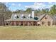 Stone home with a welcoming front porch and a well-maintained lawn at 212 Lakeview Dr, Newborn, GA 30056