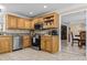 Well-lit kitchen featuring stainless steel appliances and light wood cabinets with modern countertops and tile backsplash at 212 Lakeview Dr, Newborn, GA 30056