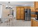 Eat-in kitchen features stainless steel appliances, wooden cabinets, and tile flooring at 212 Lakeview Dr, Newborn, GA 30056
