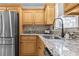 Modern kitchen featuring stainless steel appliances, granite countertops, tile backsplash and sink with black faucet at 212 Lakeview Dr, Newborn, GA 30056