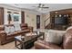 Comfortable living room with leather furniture, a TV, and access to the staircase at 212 Lakeview Dr, Newborn, GA 30056
