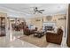 Spacious living room with a fireplace, leather sofas, a ceiling fan, and an open dining area at 212 Lakeview Dr, Newborn, GA 30056