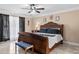 Elegant primary bedroom featuring a large wood bed frame, ceiling fan, and soft, neutral color palette at 212 Lakeview Dr, Newborn, GA 30056