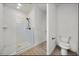 Modern bathroom with sleek glass shower, subway tile, and wood-look flooring at 2668 Brown Nw St, Atlanta, GA 30318