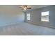 A spacious bedroom offers neutral carpet, two windows, and a ceiling fan at 128 Dalston Cv, Stockbridge, GA 30281