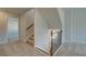 Carpeted stairway with dark brown railing, leading to the upper level at 128 Dalston Cv, Stockbridge, GA 30281