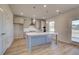 Well-lit kitchen features a large island and stainless steel appliances at 128 Dalston Cv, Stockbridge, GA 30281