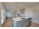 View of the kitchen featuring stainless steel appliances, island and modern lighting at 128 Dalston Cv, Stockbridge, GA 30281