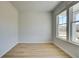 Bright office space featuring wood-look flooring and large windows offering ample natural light at 128 Dalston Cv, Stockbridge, GA 30281