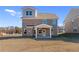 Brick two-story home featuring covered back porch and an expansive lawn at 128 Dalston Cv, Stockbridge, GA 30281